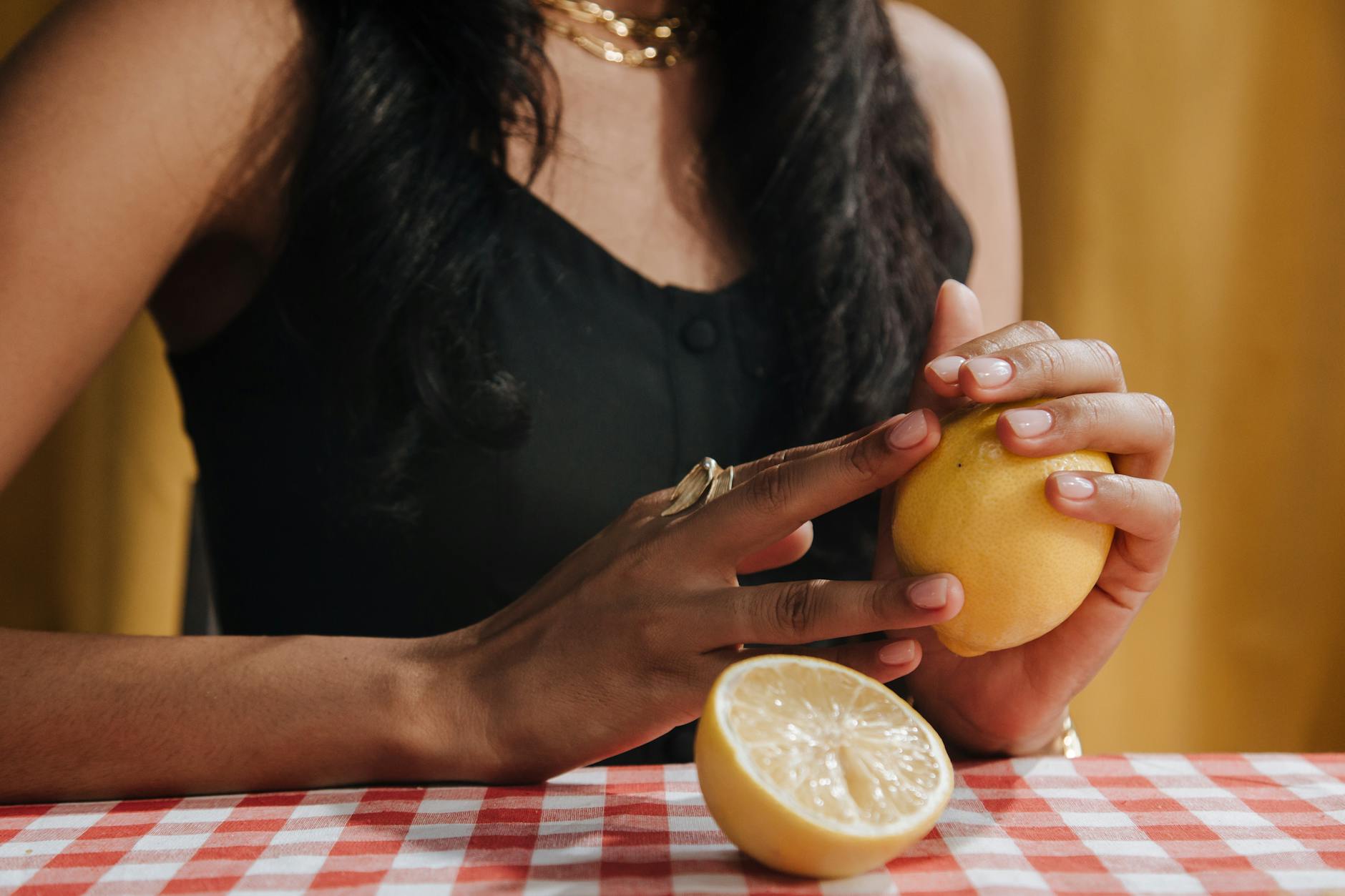 A woman holding fresh lemon, symbolizing vulnerability and natural comfort