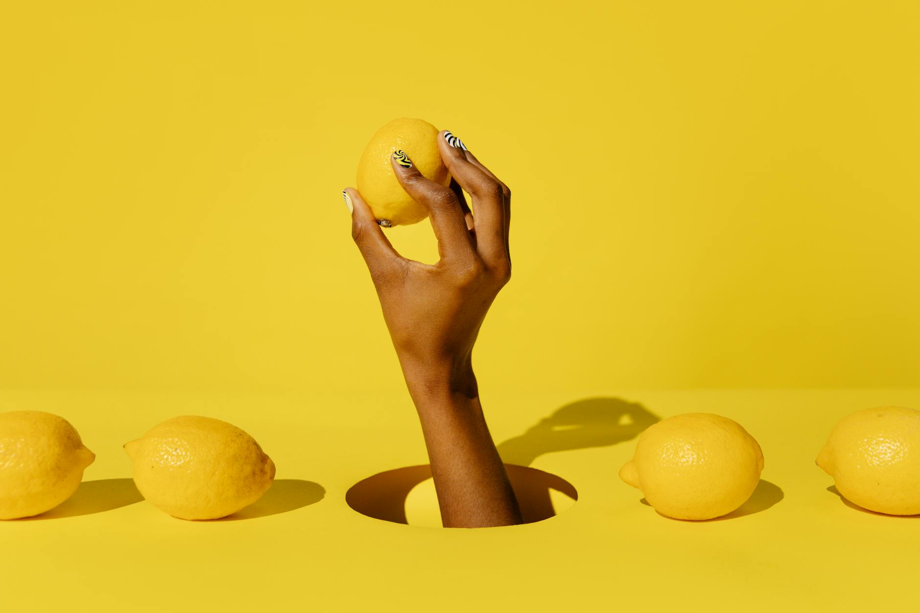 Yellow lemon vibrator on yellow background with fresh aesthetic
