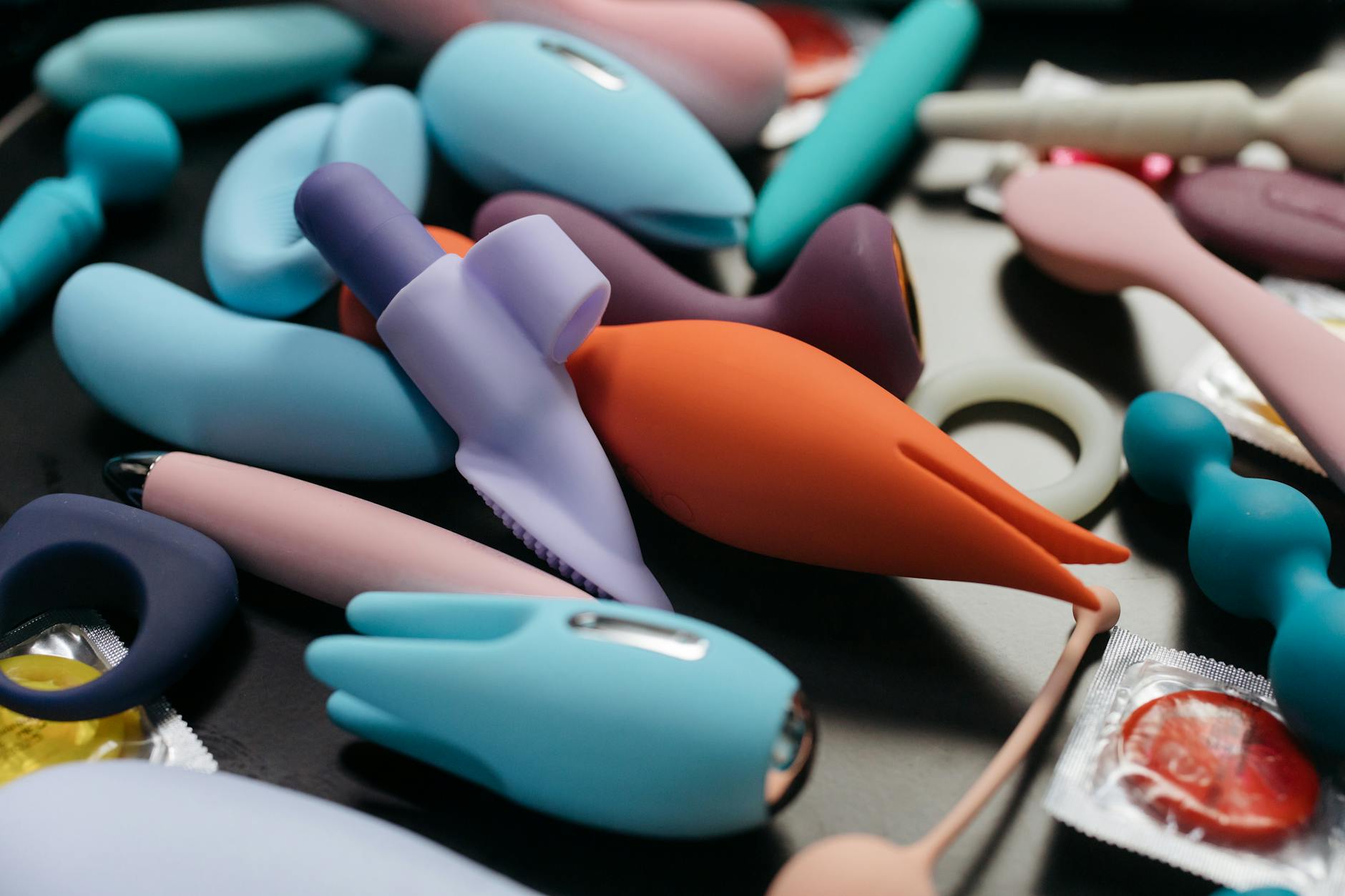 An array of colorful adult toys and vibrators displayed in close-up view