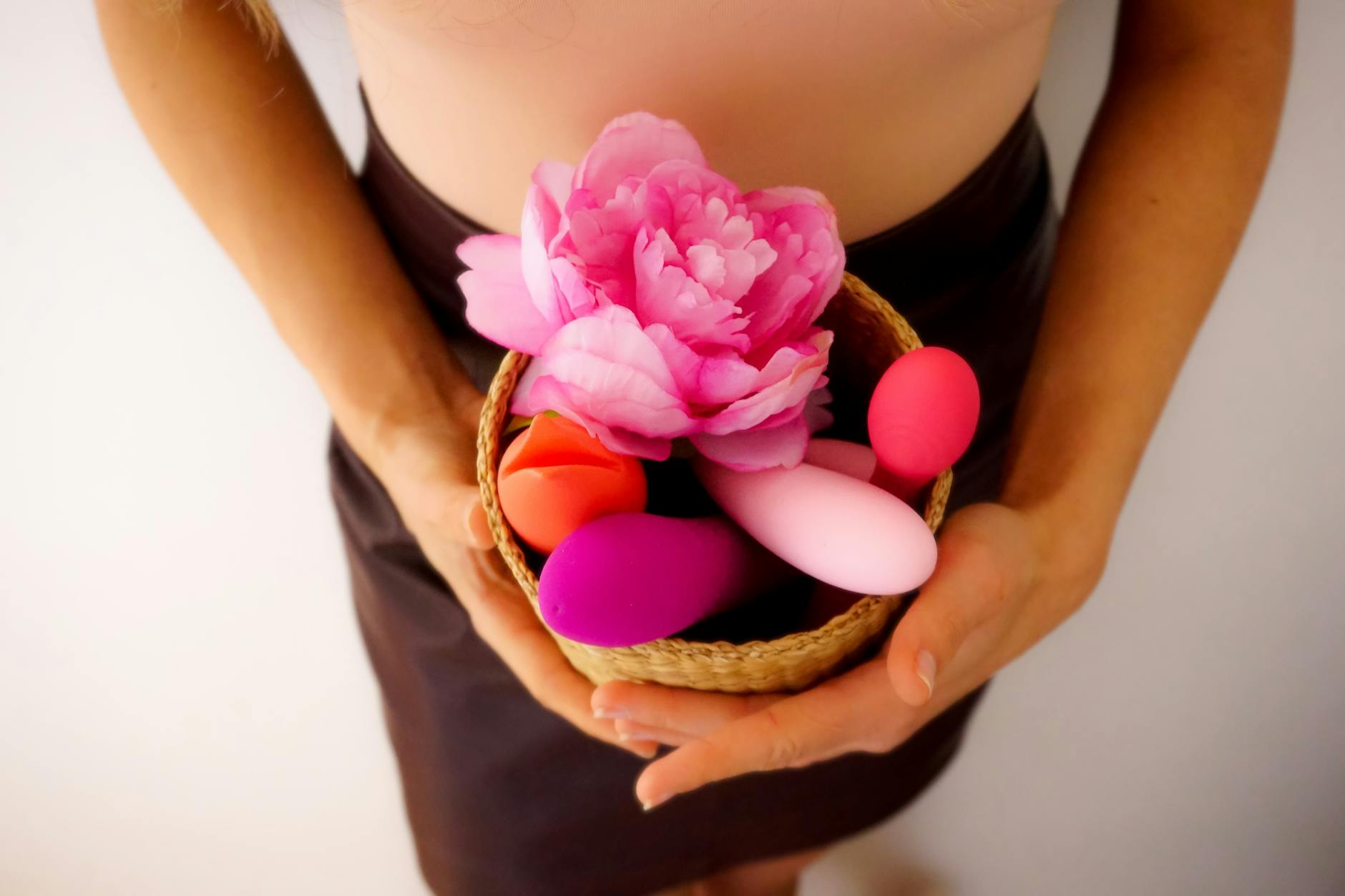 Colorful arrangement of lemon and other clitoral vibrators on a bright yellow background